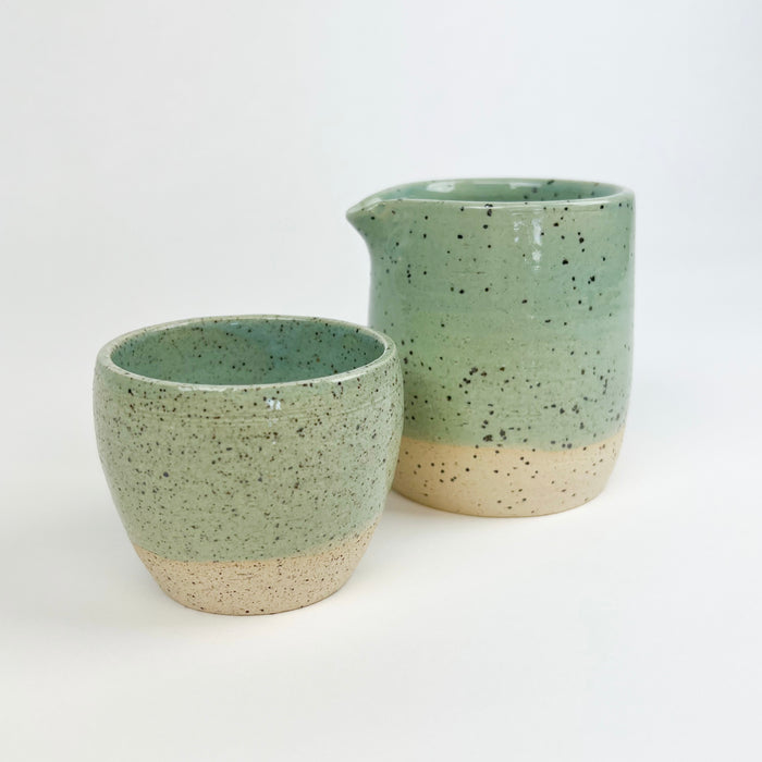 Chibiko carafe and Chibiko cup shown in the seafoam glaze. Coastal inspired stoneware hand crafted by Tamiko Claire Studio in Hawaii. Each piece sold separately.
