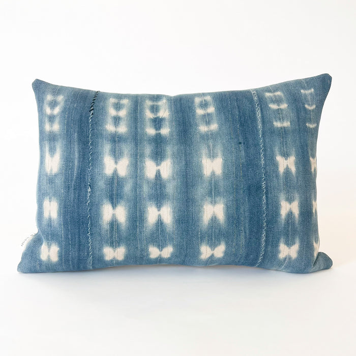Small Zola pillow in shibori 1.5 pattern. Faded indigo and natural shibori "tie dye" pattern with verticle seams and light blue and navy hand mending. Back is natural Belgian linen. Measures 19" x 13". Limited edition.