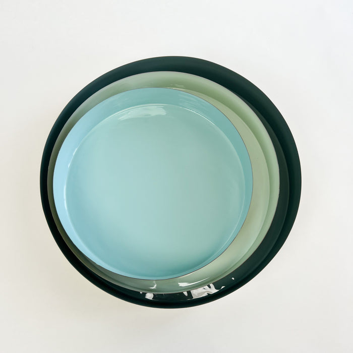 Laguna Brass Trays, set of 3 shown. Each sold separately. Round brushed brass nesting trays finished with a glossy enamel interior in shades of coastal blues. A sleek decorative accent for the coastal home.