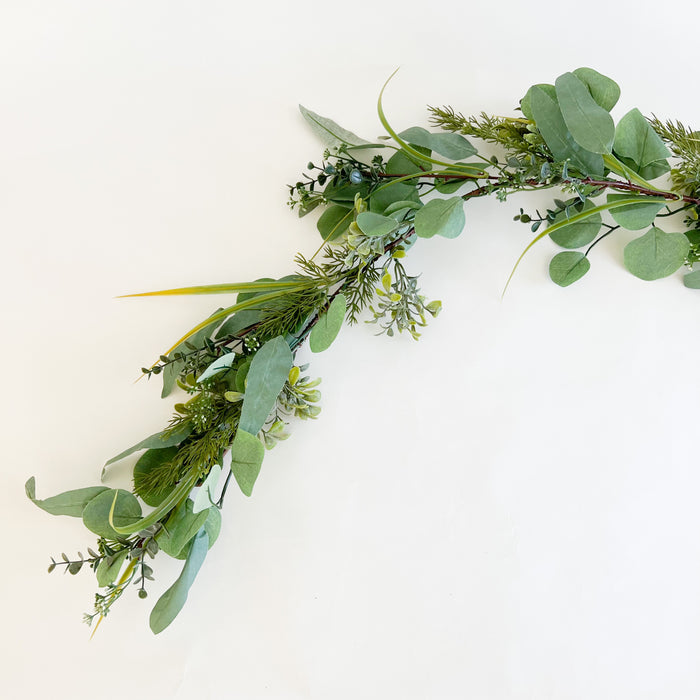 Faux Eucalyptus and Evergreen garland. Natural decor accent for stairs, mantels or tables. Life like holiday greens that stay fresh looking all season long. 72" length. 