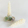 Tree shaped wax taper candles in winter cream. Packaged as set of 2 in Kraft box ready for gifting. Unscented. 5" length.