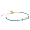 Gulf Green woven friendship bracelet in a watery shade of blue-green and white. Embellished with tiny glass and brass beads. Pull string adjuster, one size fits most.