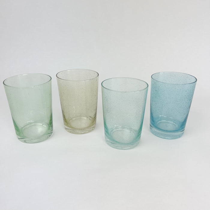 Collection of bubble glass tumblers in 4 shades of coastal inspired colors. Verde (green), amber (yellow), seagrass and turquoise. Artisan made glassware. Each glass sold individually.