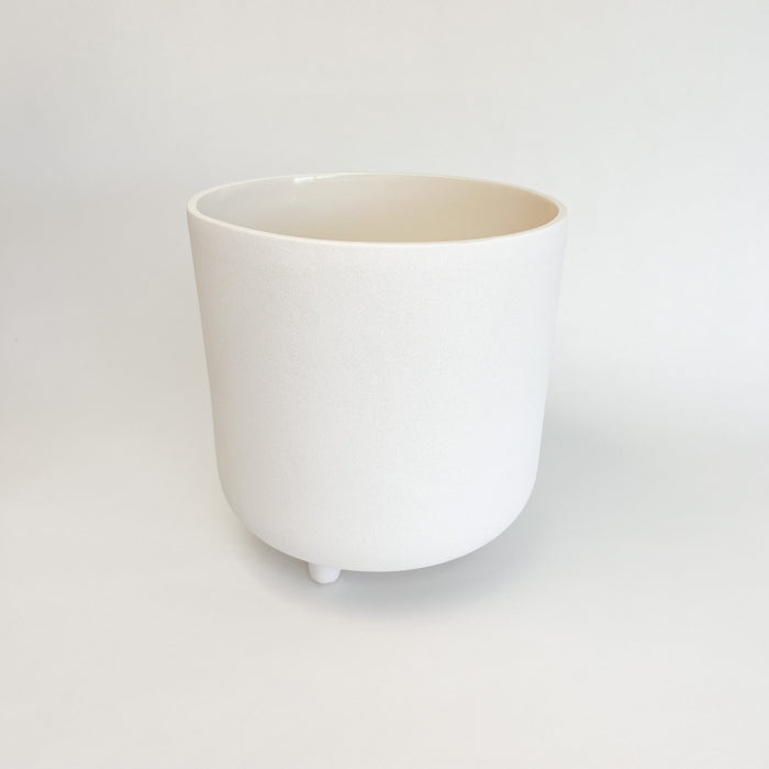 Small adobe footed vessel. Ceramic vessel finished with a matte white glaze similar to natural adobe. Perfect for adding  boho chic or modern mediterranean style to your room or patio. Small vessel measures 8" high 7.5" diameter.