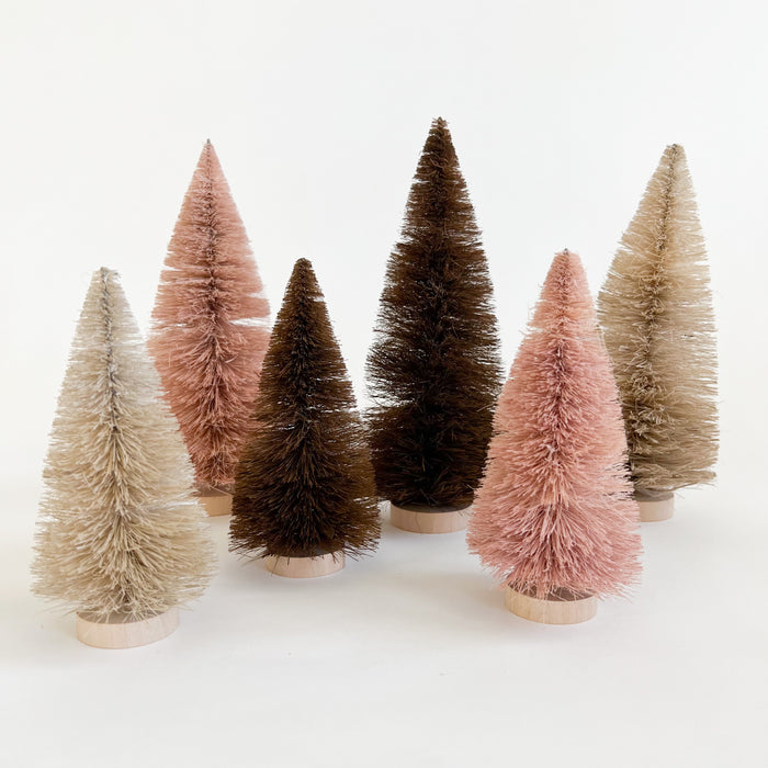 Sisal bottle brush trees shown in sand, blush and cinnamon. Natural holiday decor perfect for styling holiday vingettes. Available in two sizes, small and medium. Each sold separately.