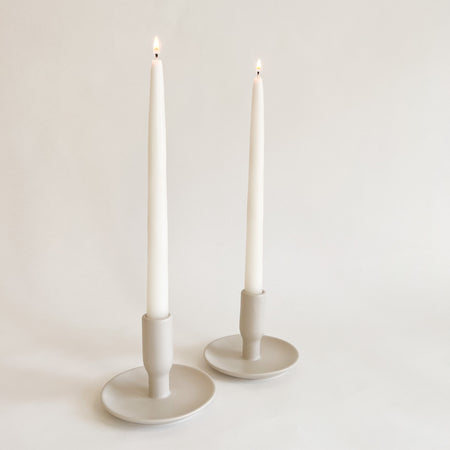Boheme ceramic candlestick holder. Finished in a soothing stone glaze. Each sold individually. Holds a standard taper. 3.75"high, 4.5" diameter at base.