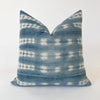 Square Zola pillow in pattern "shibori 1.0". Faded indigo and natural shibori "tie dye" pattern with horizontal hand mending in cobalt and white thread. Natural Belgian linen back. Measures 20" x 20". Limited edition.