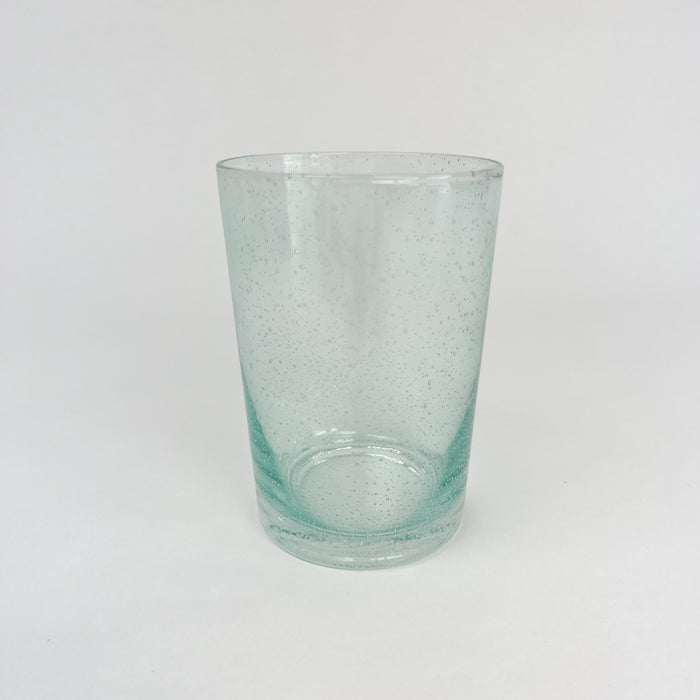 Seagrass bubble glass tumbler. Artisan made glassware with little bubbles floating throughout. Holds approximately 8 oz. Each sold separately.
