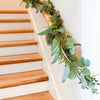 Faux Eucalyptus and Evergreen garland on stairs. Life-like faux holiday evergreens. Perfect for stairs, mantles or tables. 72" length. Indoor use only.