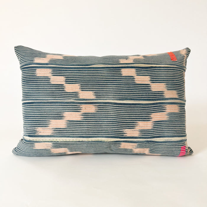 Small Amara pillow made from indigo and blush Baule cloth. Fine indigo and natural stripes with a soft pink zig zag pattern. Hand stitched blocks in orange and fuchsia alone the right side. Natural Belgian linen back. Measures 19" x 13". Limited edition.