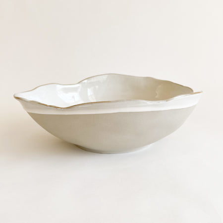 Extra large Shoreline bowl. Hand shaped ceramic bowl inspired by shells and beach pebbles. Finished in a matte grey glaze with a glossy white interior. Perfect decorative accent for the coastal home. 9" diameter, 3" height.