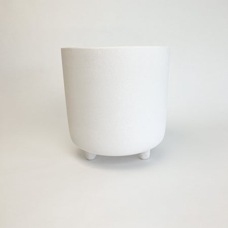 Medium adobe footed vessel. Ceramic pot finished with a matte white glaze similar to natural adobe. Add modern Mediterranean or boho chic style to your room or patio. Medium measures 9.25" high 9" diameter.