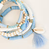 Heishi surf bracelets. Set of 6 stretch bracelets in white, light blue and gold with tassel and shell charms. Stretch bracelets, one size fits most.