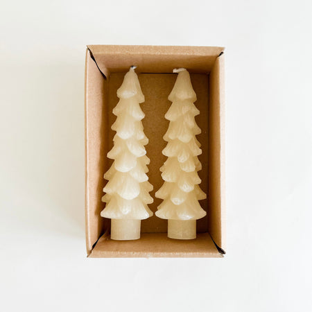 Tree shaped wax taper candles in cream color. Set of two comes in a Kraft box ready for gifting. Unscented. Standard taper base, 5" tall.
