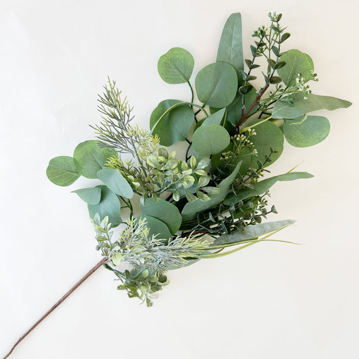 Faux Eucalyptus and Evergreen stem. Ideal for adding texture to a Christmas tree or layering in the look of fresh holiday greenery to your decor. Wired stems for easy styling. Indoor use only. 31.5" length