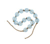 Strand of blue beach glass beads strung and knotted on jute twine. Measures 34" end to end. Each ball is 1.25" diameter.