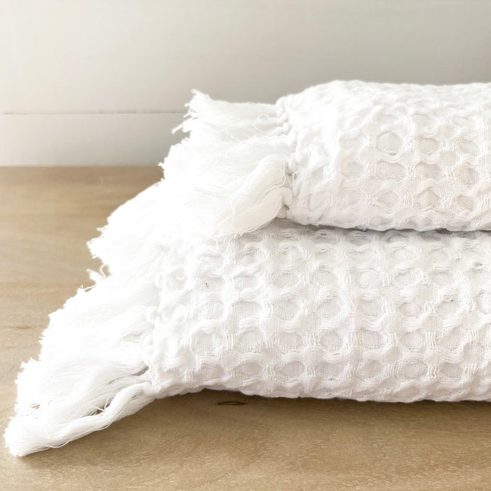 Alys Waffle Towels, hand and bath towel shown. White super absorbent waffle weave towel with hand knotted tassel ends. Hand towel 21 x 32 inches, Bath towel 34 x 70 inches. Each sold separately.
