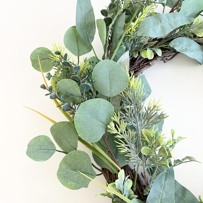 Faux Eucalyptus and Evergreen wreath. Life-like holiday greenery with wired stems. Indoor use only.