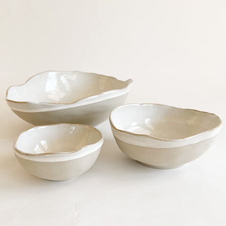 Shoreline ceramic nesting bowls. Hand shaped organic forms inspired by shells and beach pebbles. Decorative accent for coastal home. Each sold separately.
