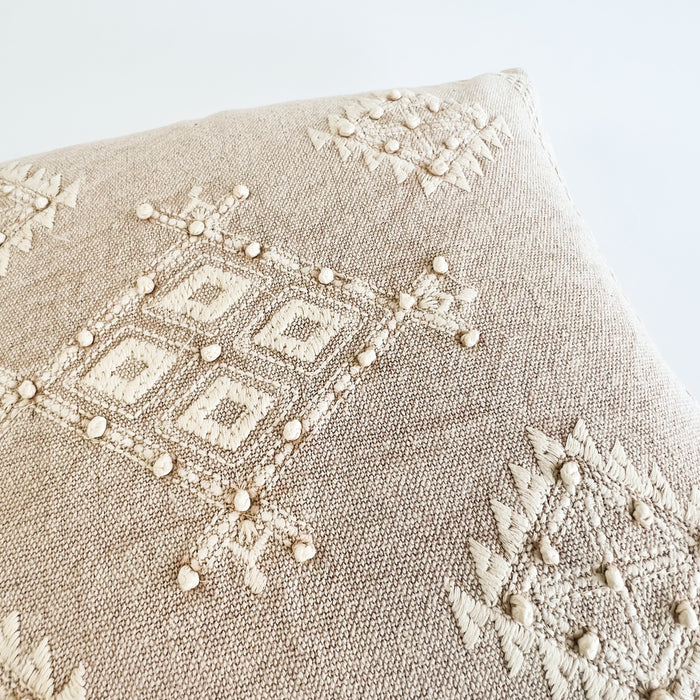 Close up for the detailed hand embroidery on the Sahara Pillow. Sandy neutrals mixed with creamy embroidery make the perfect accent for the modern bohemian home. Measures 18" square. Insert is included.