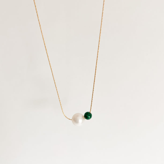 Etain necklace, named after the Celtic Goddess of Transformation. A simple 14K gold filled chain with a hand carved Malachite sphere and natural pearl. Hand made in the US by Kozakh. 16 to 18 inch length.