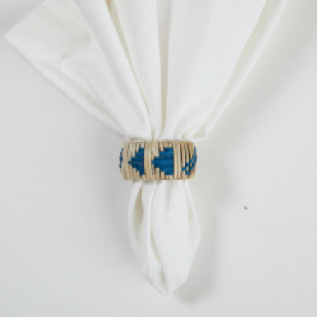 Napkin ring made from hand woven cane. Natural colored cane base with indigo triangular pattern. Each sold individually.