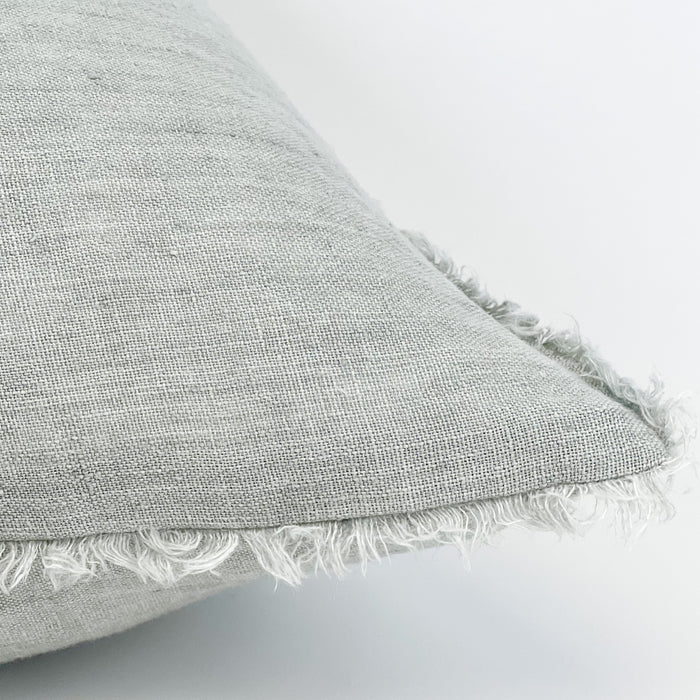 The linen fringe pillow in fog grey is finished on all four sides with a natural fringe edge. The luxurious 24" square is filled with a soft down insert. It's the perfect foundation pillow for layering with other patterns and textures.