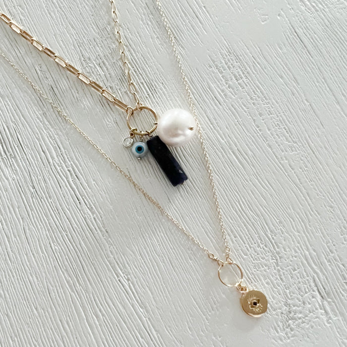 Mykonos Charm Necklace shown with the Eye on You necklace. Both handcrafted in the USA. 14K gold filled chains. Inspired by ancient greek symbolism believed to ward off bad energy and bring good luck.Each sold separately.