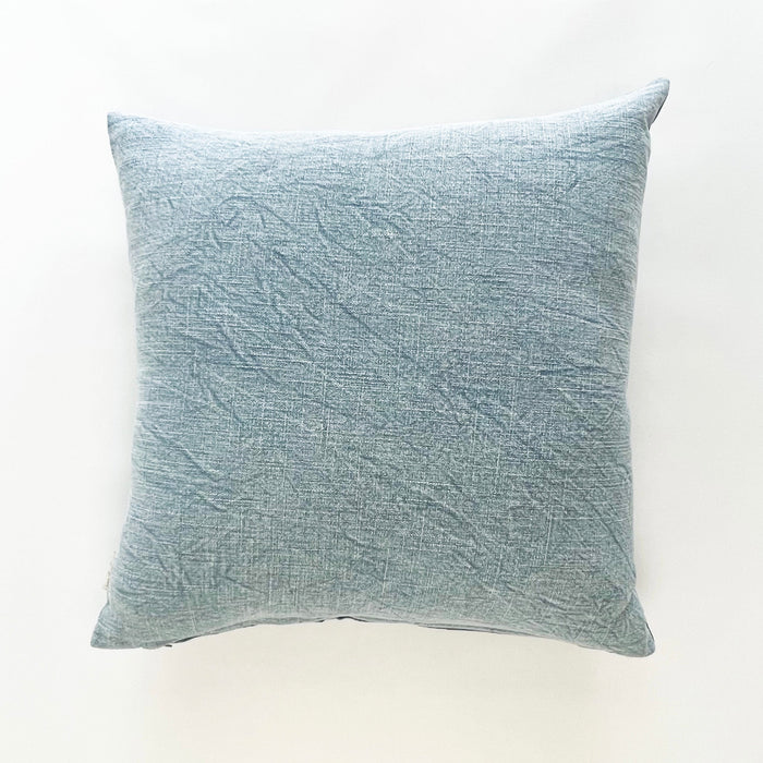 Blue crush pillow in pale stonewashed indigo linen. Stonewashing gives the pillow a sun faded look and pulls up the natural highs and lows of the artisan dyeing technique. Measures 20" square, down insert included.