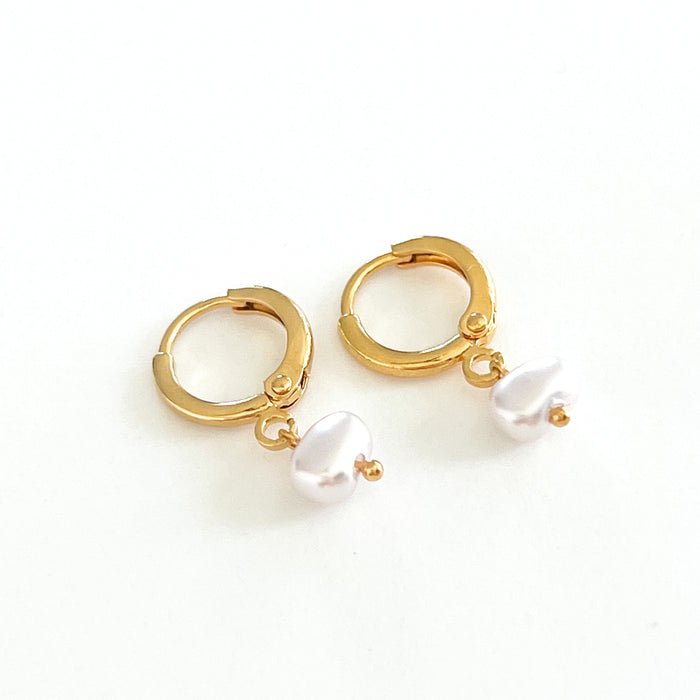 Pair of 14K gold filled hoop earrings with a fresh water pearl charm. Hoop measures 12mm, 4mm pearl.