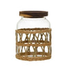 Medium clear glass canister with hand woven lattice rattan sleeve. A natural Acacia wood lid with seal keeps dry goods fresh. Holds 42 oz.  6 inch tall, 4.5" diameter.