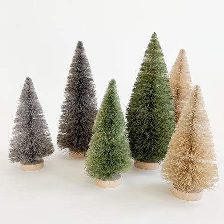 Sisal bottle brush trees shown in grey, winter pine and sand. Available in two sizes small and medium.  Natural holiday decor accent for holiday vignettes. Each sold separately.