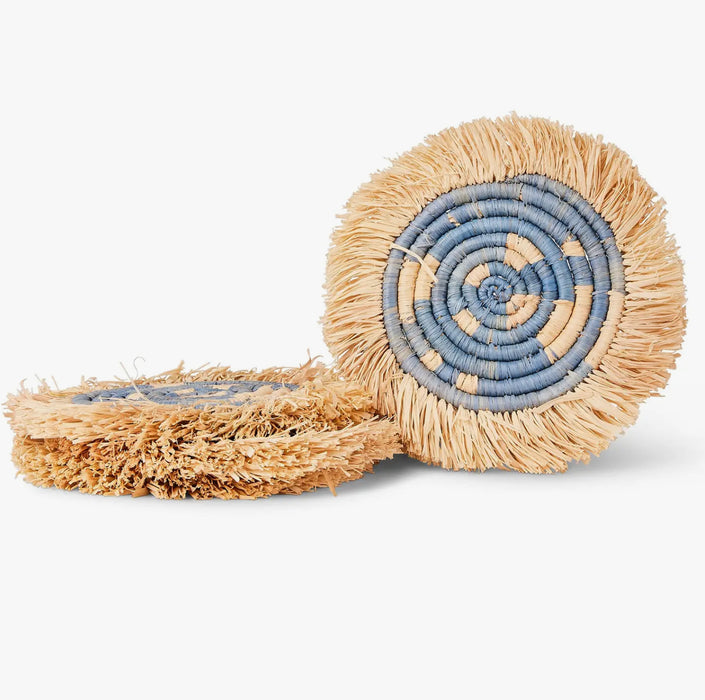Set of four coastal seagrass coasters hand woven in dyed blue and natural grasses. Finished with a raffia edge. Measures 6" diameter.