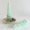 Tree shaped wax taper candles in mint green color. Set of 2 comes in Kraft box ready for gifting. Unscented. 5" length.