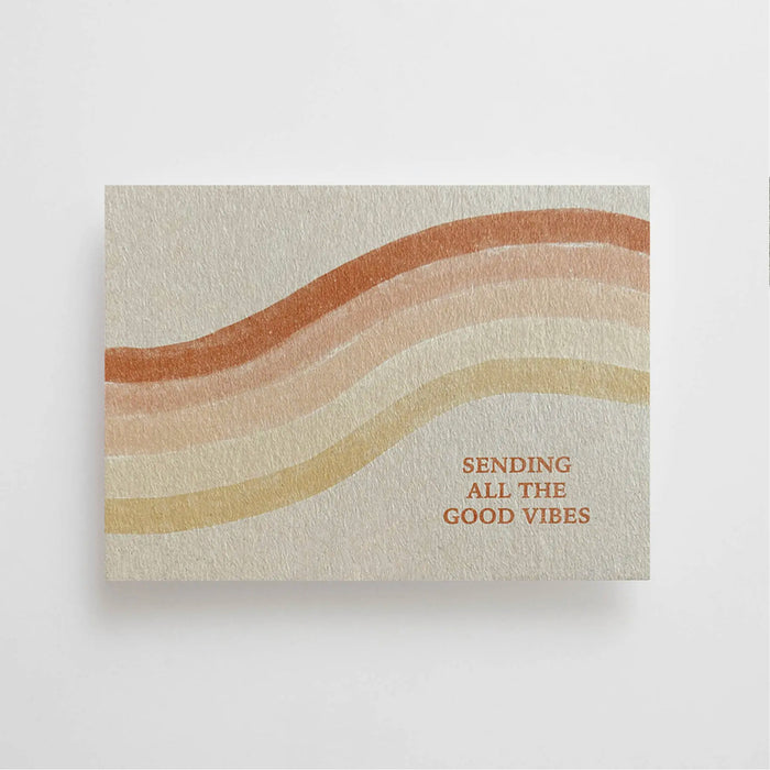 Sending all the good vibes postcard featuring a water color rainbow in shades of rust, blush and tan. Printed on thick high quality natural Finn board. Back left blank for note writing. 5.75" x 4.125".