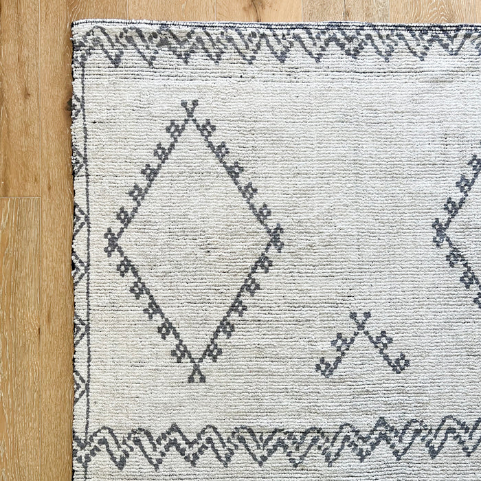 La Paz rug adds bohemian style to any room. Hand knotted cotton with a charcoal grey diamond and zig zag pattern on a cream base. 4' x 5.8'