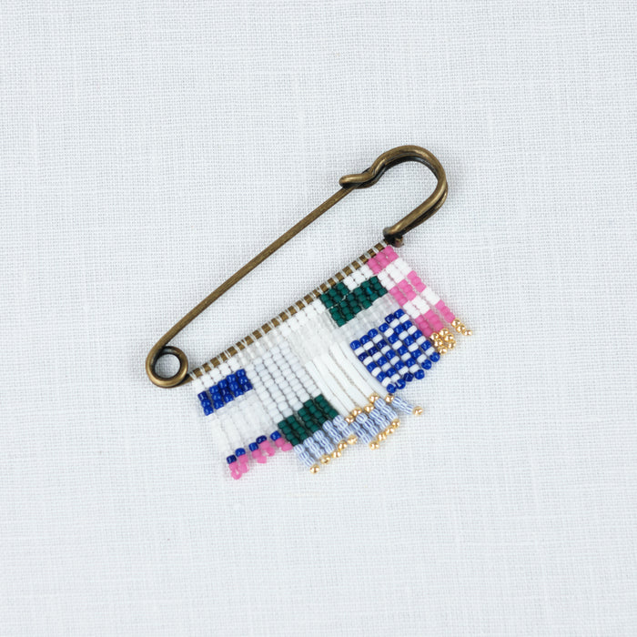 Brass Pin with blue, white, green & bright pink bead. A graphic friendship pin by Alice Rise.