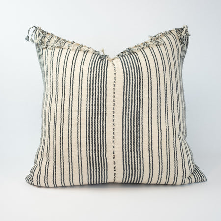 Luna Pillowcover, one of a kind made from handwoven tribal fabric in ecru and rich indigo stripes. One edge is finished with hand twisted fringe. Perfect for the modern coastal boho home. Measures 20" x 20". Insert NOT included.