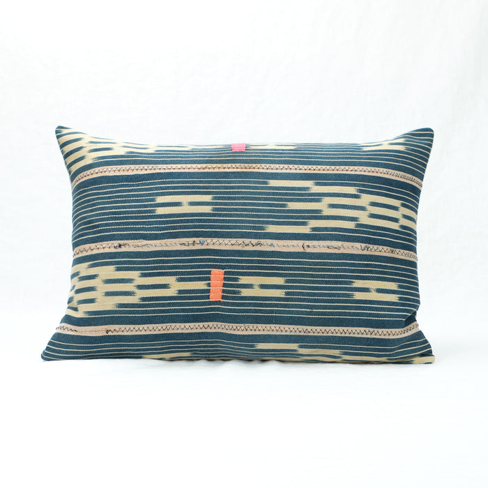 Indigo Baule Pillow with neon pink and orange decorative stitching. Small rectangular shape.