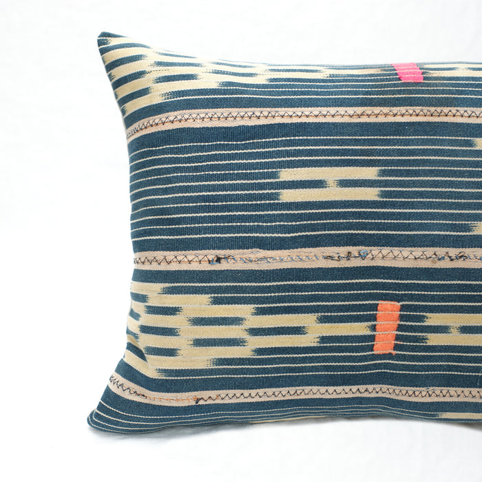 Close up of Indigo Baule Pillow made from vintage fabric showing zig zag stitching and hand mending.