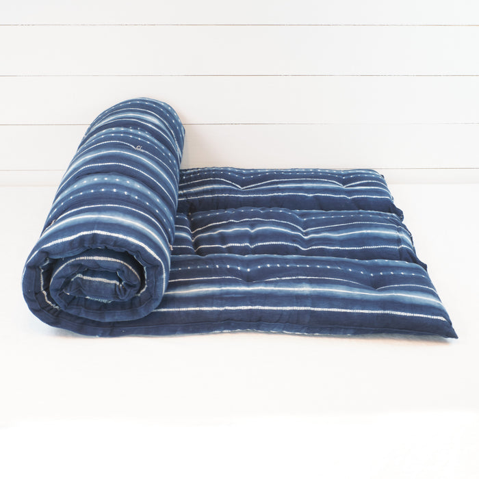 Tensira cotton bedroll in an indigo tie dye stripe.