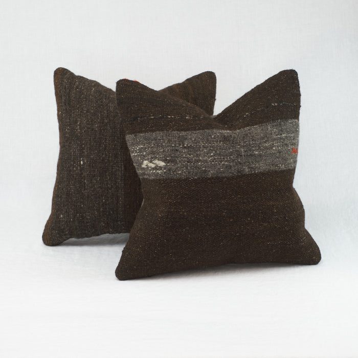 Pair of pillows, Nomad 1 and Nomad 2 made from a vintage wool kilim. Colors are espresso brown with dark grey stripe.