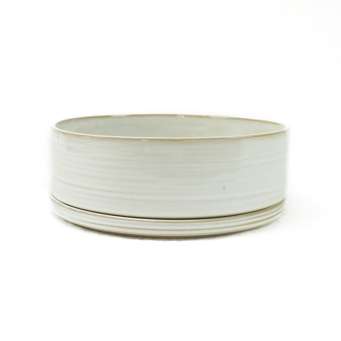 Round ceramic serving dish and plate handmade in a grey-white glaze.